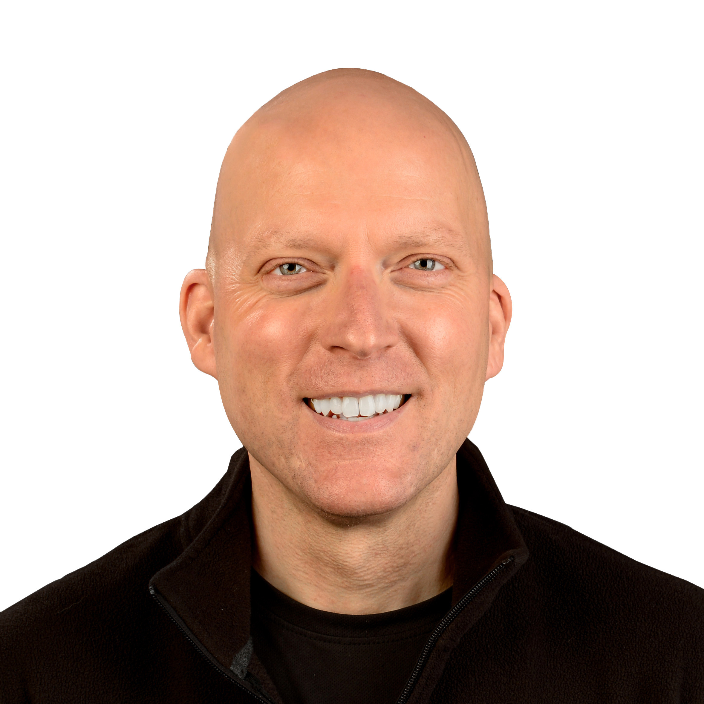 Professional headshot of a man with blue eyes, and bald head wearing a black zip up track jacket and a black tshirt against a white background.