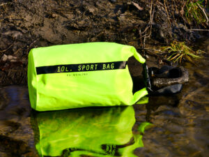Lifestyle image of a waterproof bag sitting in a river