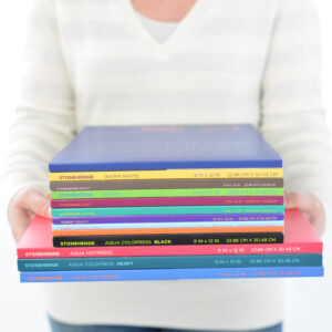 Lifestyle photo of a person holding sketchbooks