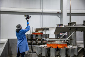 Person on-site photographing food manufacturing facility