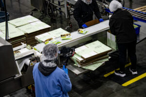 Person on-site photographing food manufacturing facility